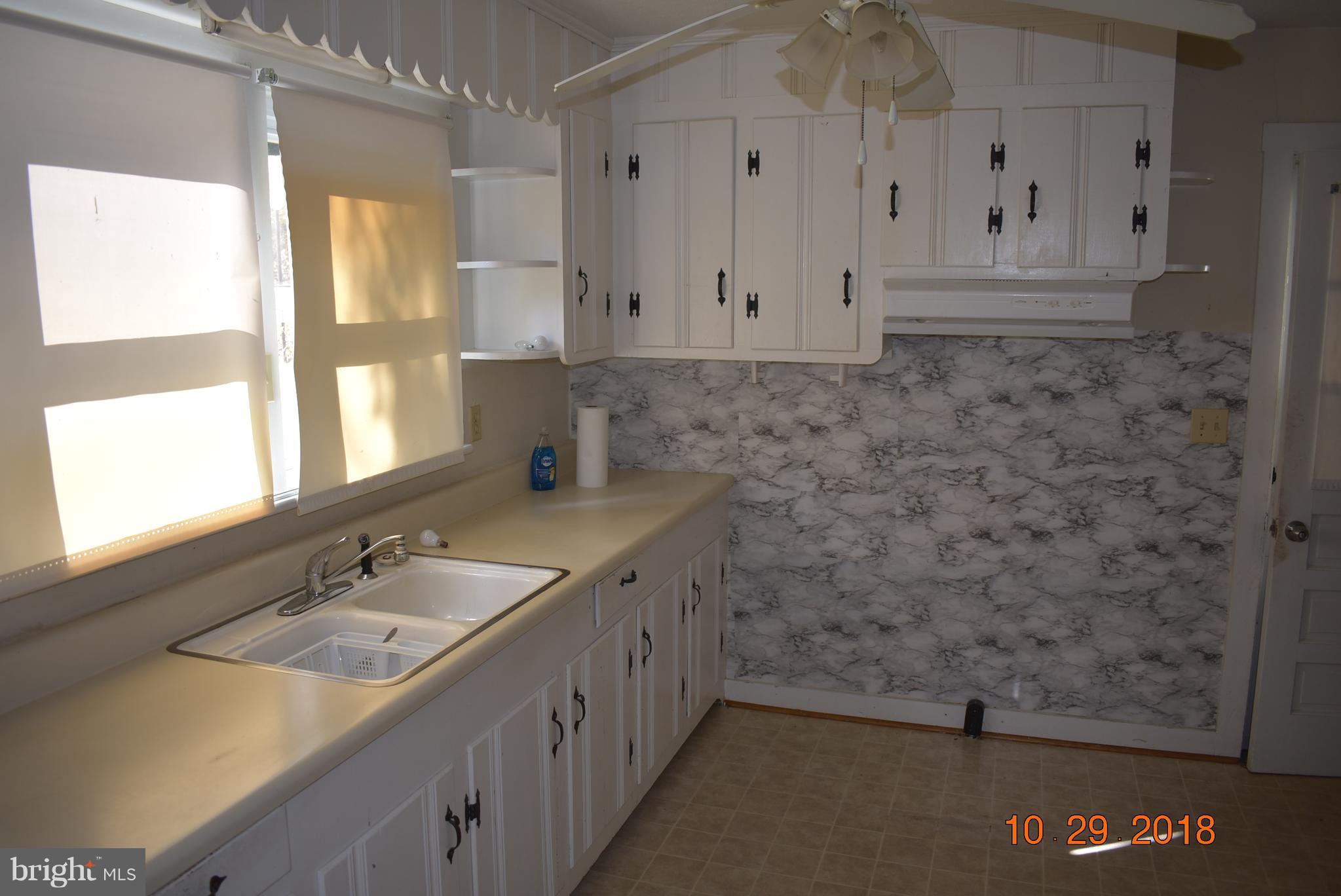 14210 Exline Road Hancock, MD 21750 - Photo 7 of 26 a bathroom with a granite countertop sink and a mirror
