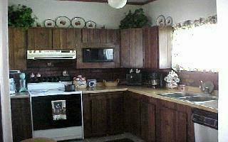 370 Noye Road Tieton, WA 98947 - Photo 7 of 7 a kitchen with kitchen island granite countertop a sink stove and cabinets