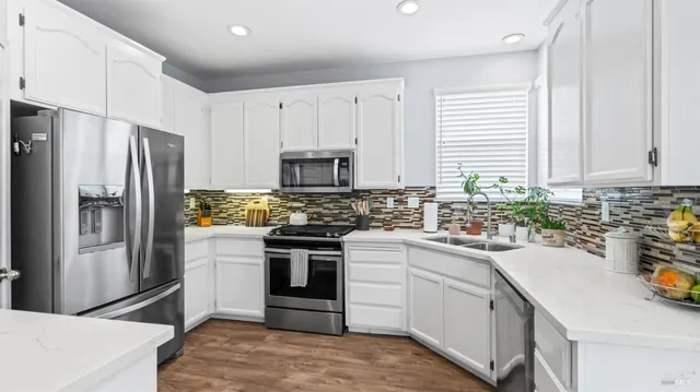 a kitchen with a sink stove and refrigerator