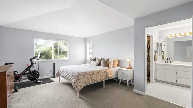 a room with a bed and a large window