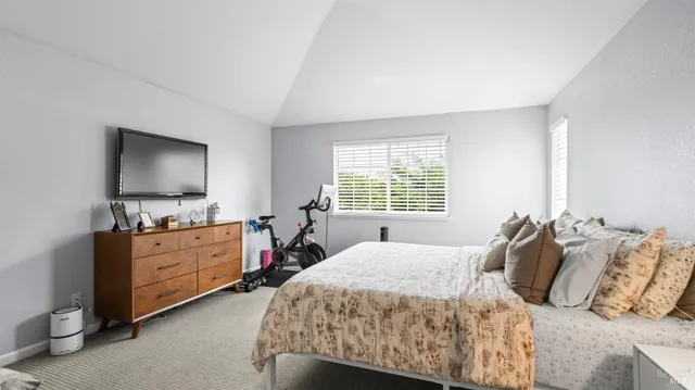 a bedroom with a bed and flat screen tv