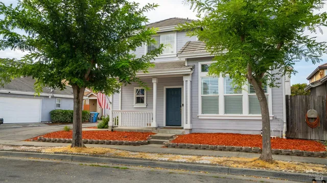 a house that has a tree in front of it