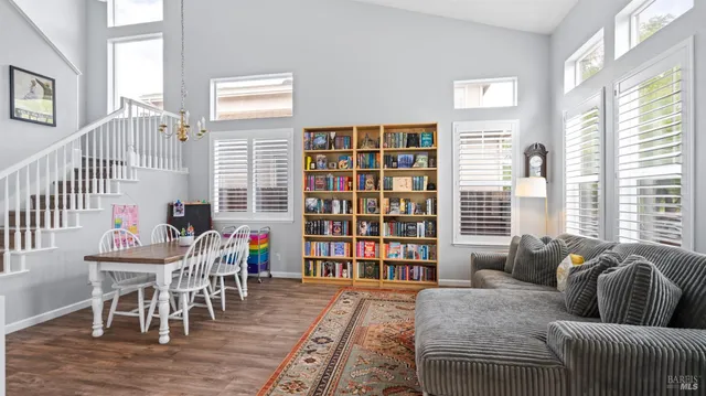 a living room with furniture and a book shelf