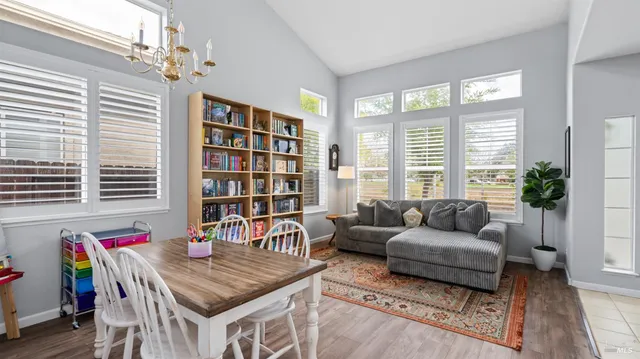 a living room with furniture and a book shelf