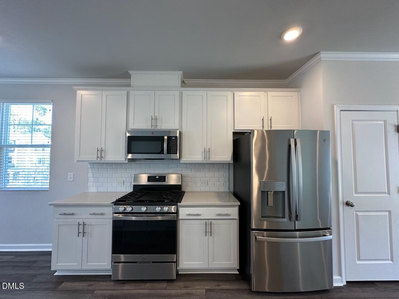 2521 Laurel Valley Way Raleigh, NC 27604 - Photo 10 of 25 a kitchen with stainless steel appliances granite countertop a refrigerator stove and microwave