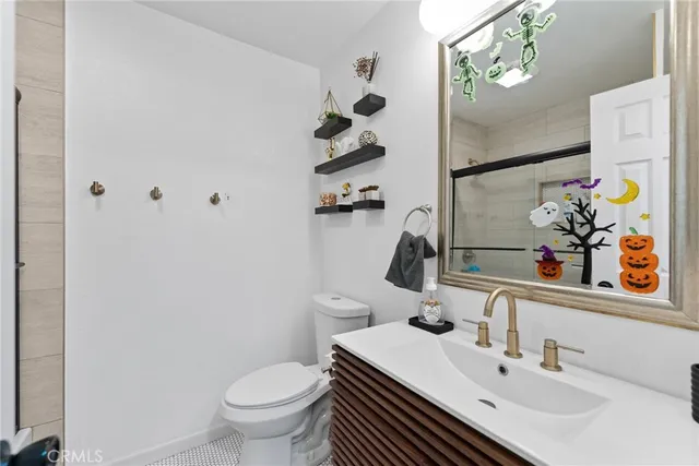 a bathroom with a sink toilet and mirror