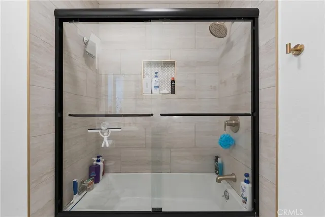 a bathroom with a bathtub and a shower