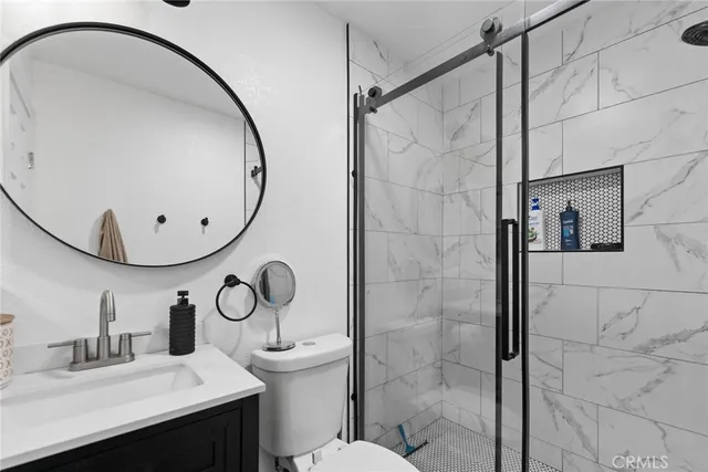 a bathroom with a sink mirror vanity and toilet
