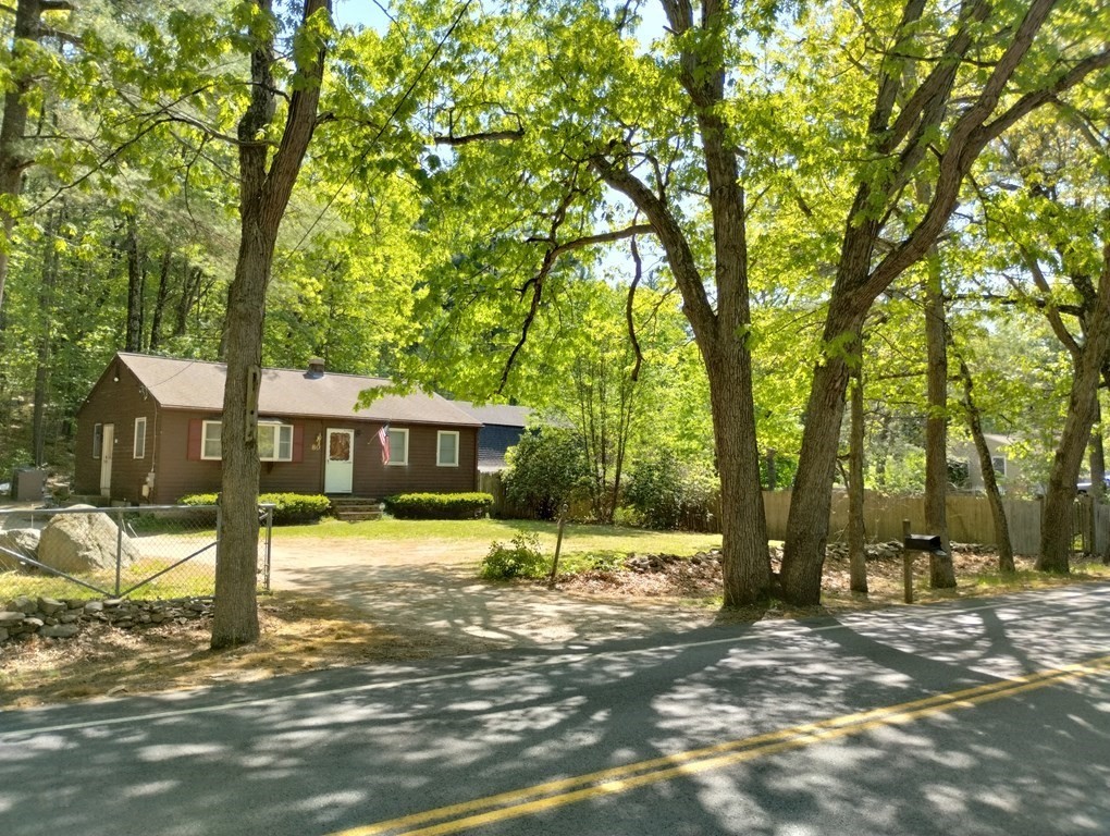 a view of a house with a tree in the background
