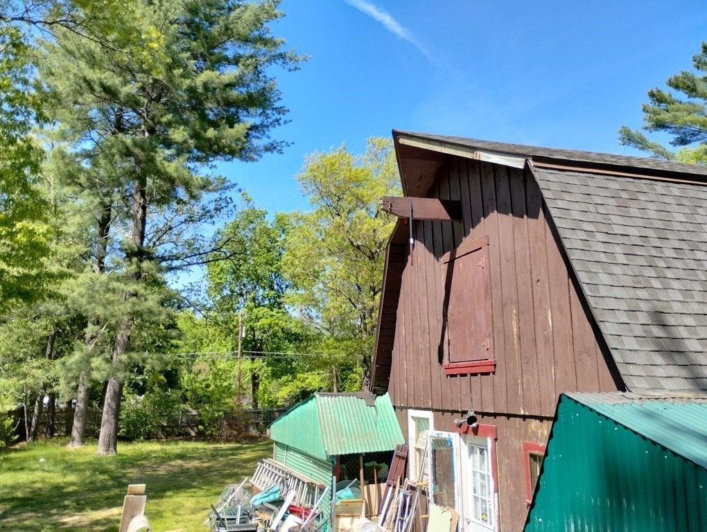 80 Forge Village Road Groton, MA 01450 - Photo 3 of 10 a backyard of a house with lots of green space