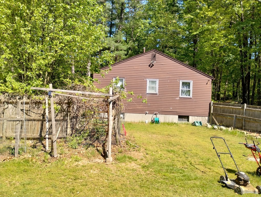 80 Forge Village Road Groton, MA 01450 - Photo 6 of 10 a backyard of a house with table and chairs