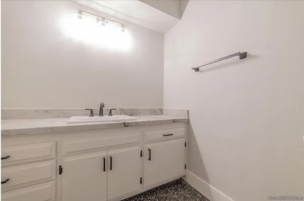 a bathroom with a sink and vanity