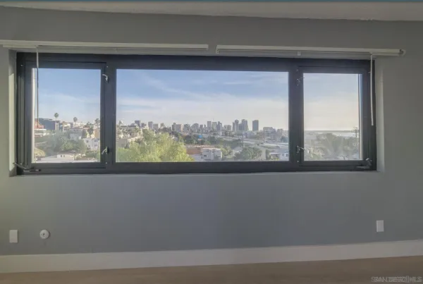 a view of a glass door with a city view