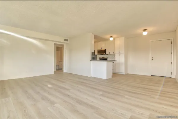a view of a kitchen with a sink and a refrigerator