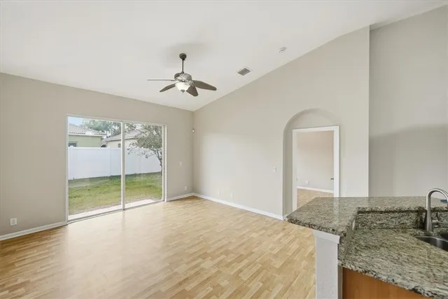 a view of a livingroom with a furniture and chandelier fan