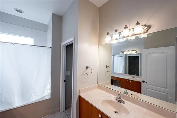 a bathroom with a double vanity sink and a mirror