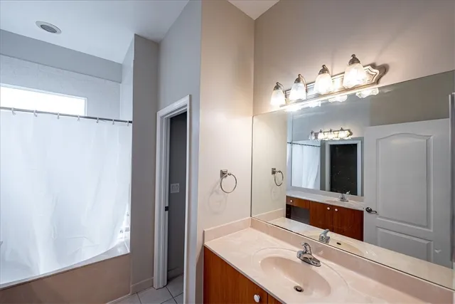 a bathroom with a double vanity sink and a mirror