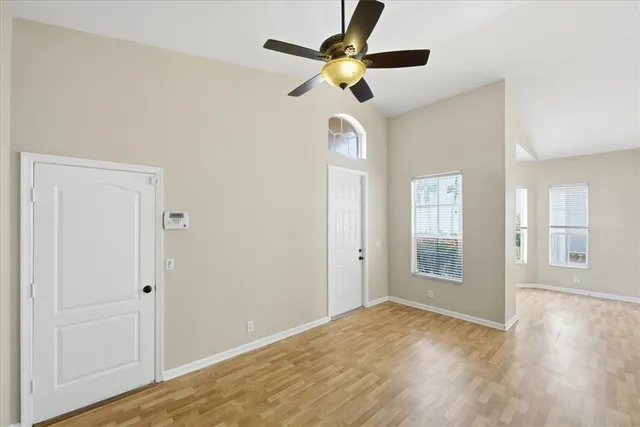 a view of empty room with wooden floor
