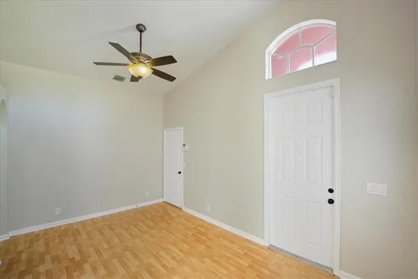 a view of a room with a ceiling fan and a window