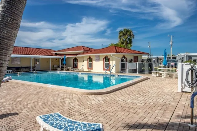 a view of house with swimming pool outdoor seating