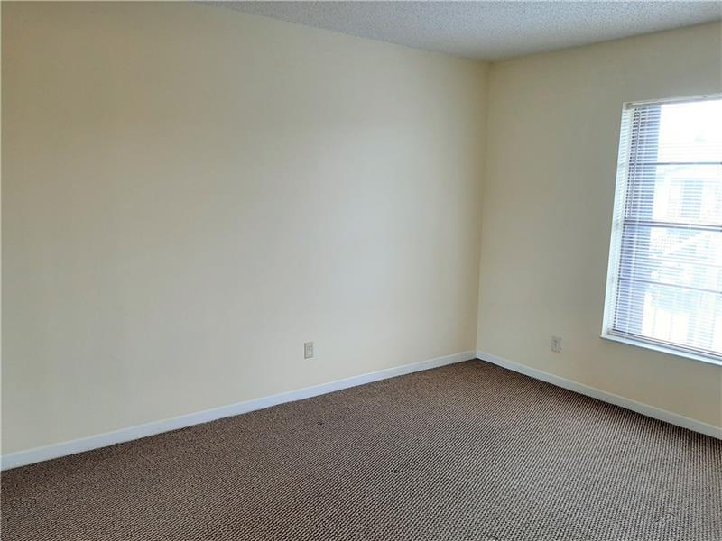 9466 Boca Cove Circle, Unit 310 Boca Raton, FL 33428 - Photo 14 of 22 an empty room with a window