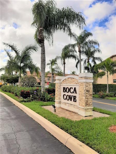 9466 Boca Cove Circle, Unit 310 Boca Raton, FL 33428 - Photo 19 of 22 a sign on the side of a building