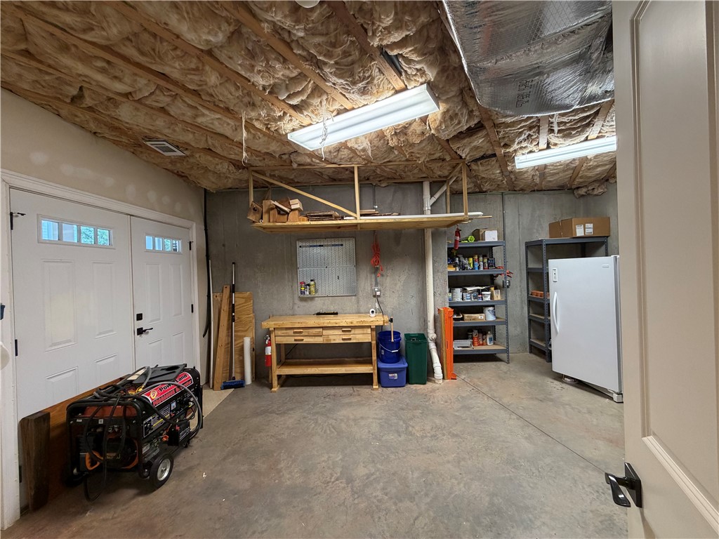 357 Stardust Lane Seneca, SC 29672 - Photo 46 of 50 Lake Room/ Workshop - An unfinished basement workshop provides concrete floors and ample room for storage or projects,