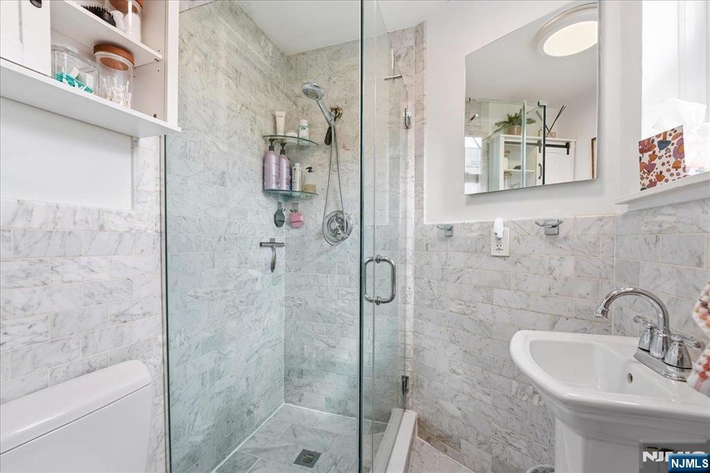 63 Madison Street, Unit 6 Hoboken, NJ 07030 - Photo 11 of 16 a bathroom with a sink toilet and shower