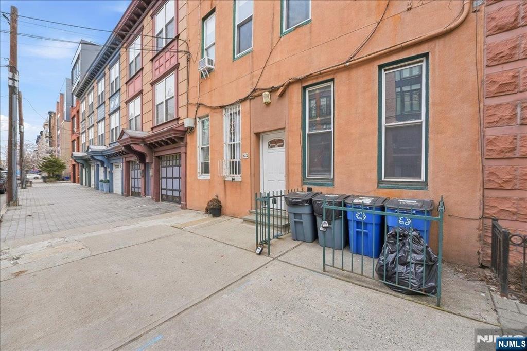 63 Madison Street, Unit 6 Hoboken, NJ 07030 - Photo 14 of 16 a view of a brick building with many windows