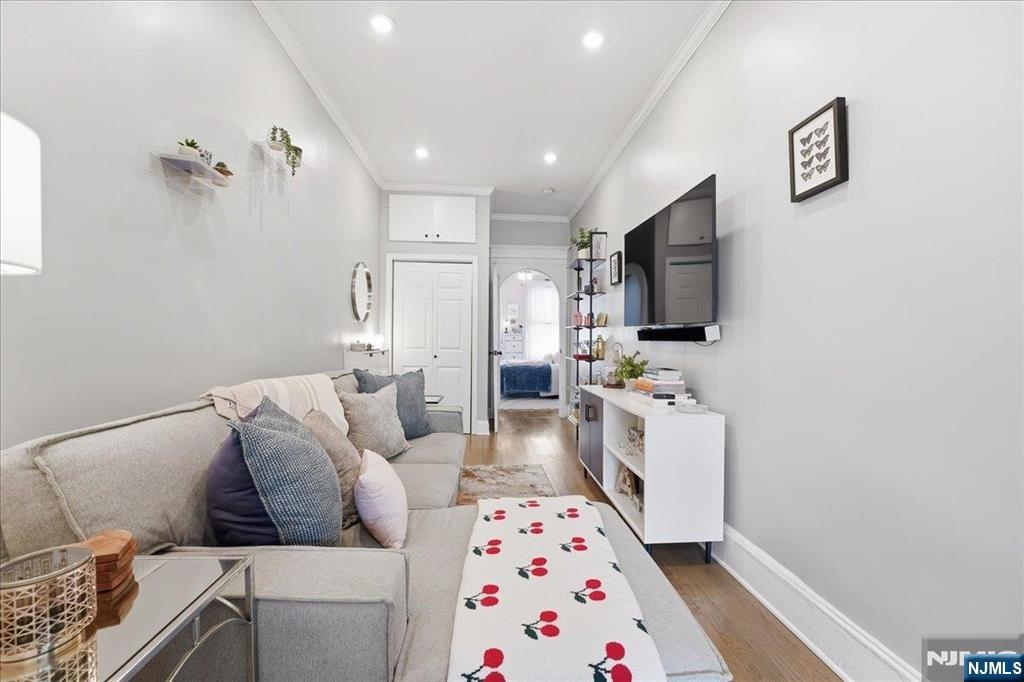63 Madison Street, Unit 6 Hoboken, NJ 07030 - Photo 3 of 16 a living room with furniture and a flat screen tv