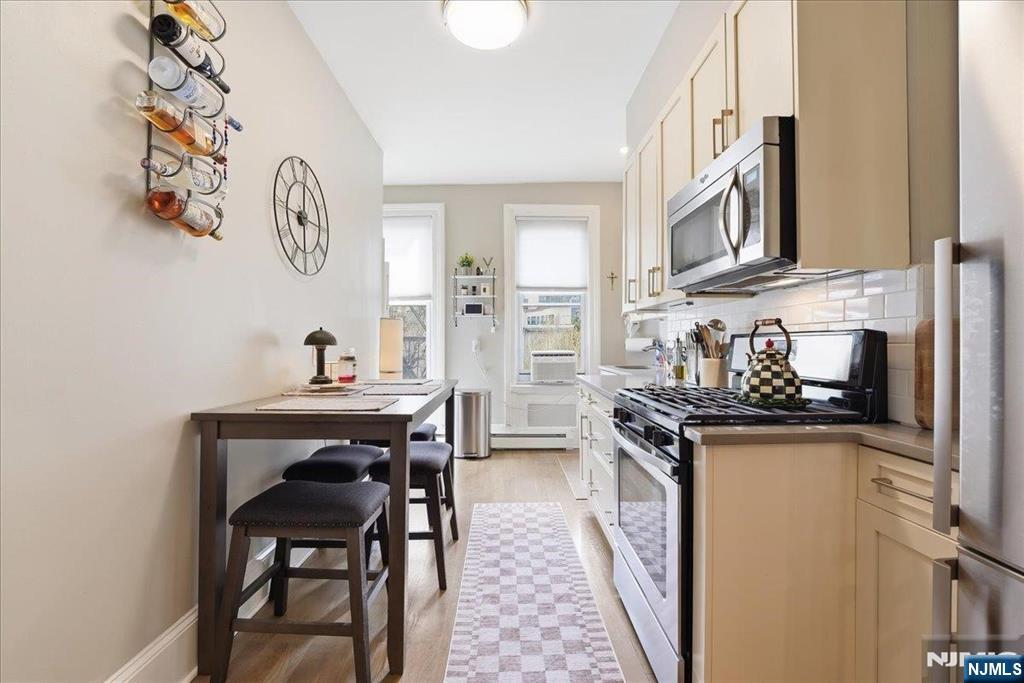 63 Madison Street, Unit 6 Hoboken, NJ 07030 - Photo 4 of 16 a kitchen with stainless steel appliances a stove a sink and a refrigerator