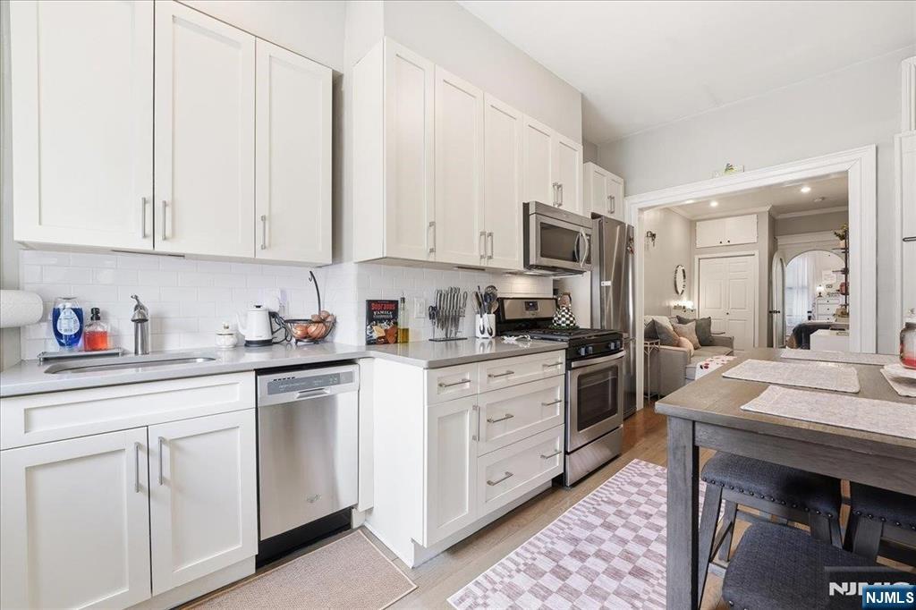 63 Madison Street, Unit 6 Hoboken, NJ 07030 - Photo 6 of 16 a kitchen with cabinets appliances and a counter space