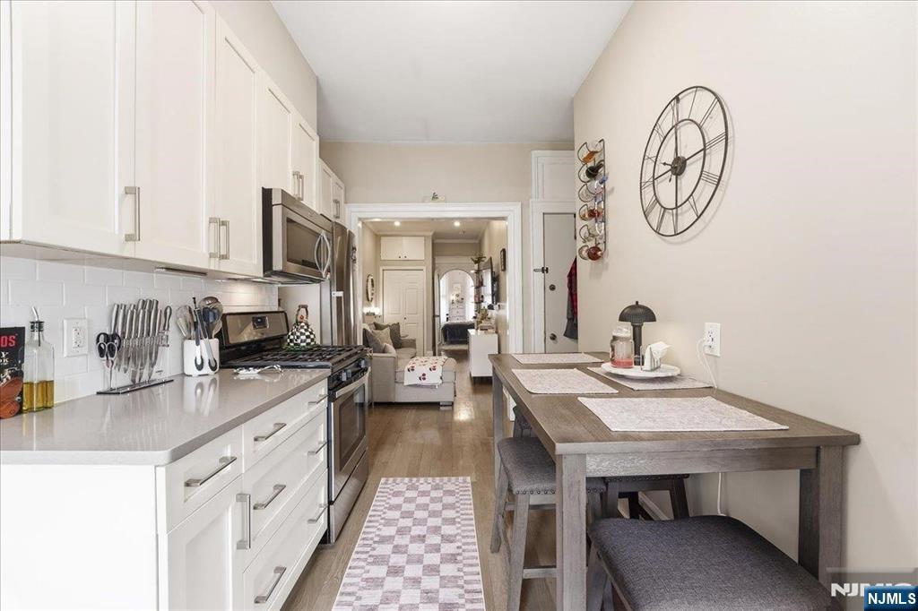 63 Madison Street, Unit 6 Hoboken, NJ 07030 - Photo 7 of 16 a kitchen with a sink a stove and cabinets