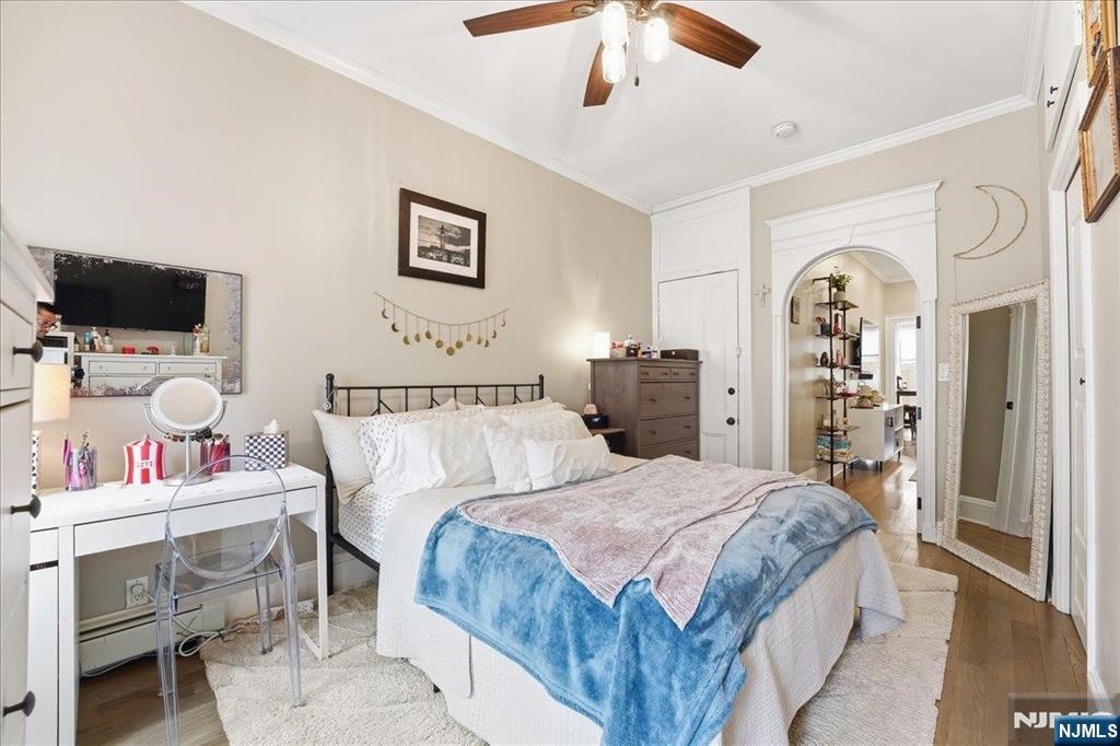 63 Madison Street, Unit 6 Hoboken, NJ 07030 - Photo 8 of 16 a spacious bedroom with a bed and a flat screen tv