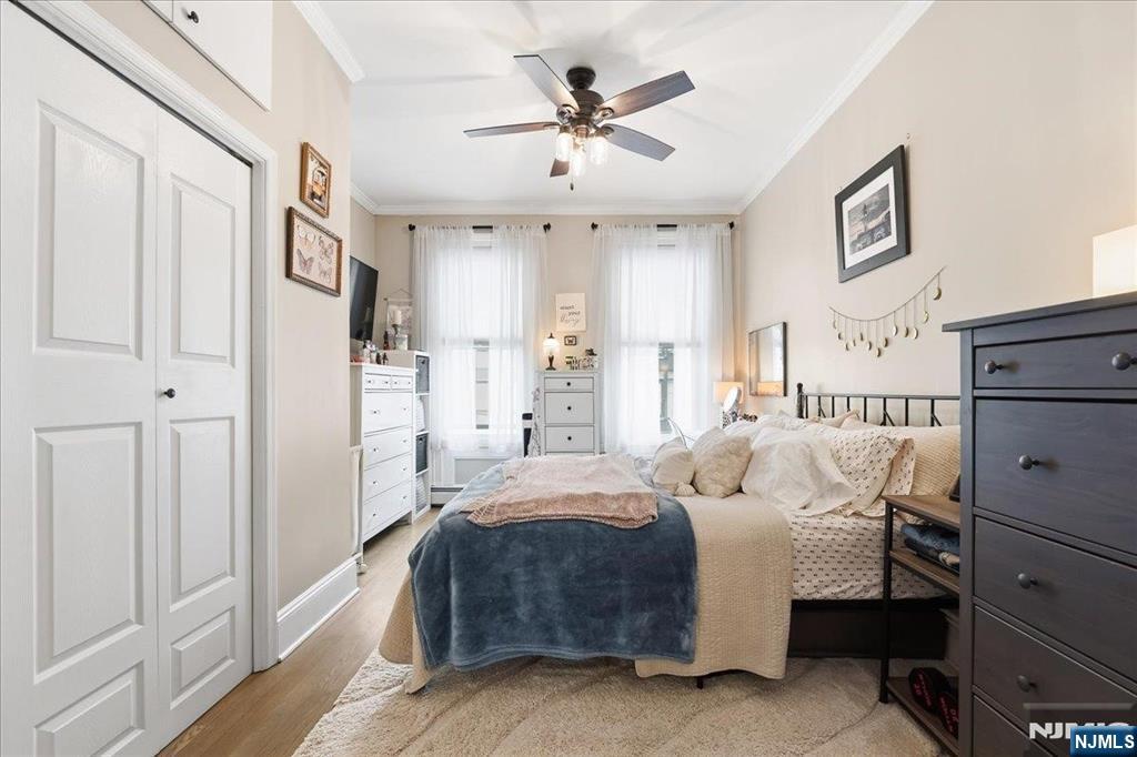 63 Madison Street, Unit 6 Hoboken, NJ 07030 - Photo 10 of 16 a bedroom with a bed and a ceiling fan