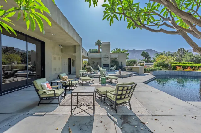 a view of a backyard with sitting area and garden