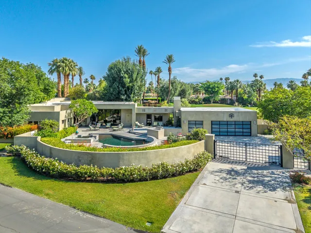 a view of a house with swimming pool and sitting area
