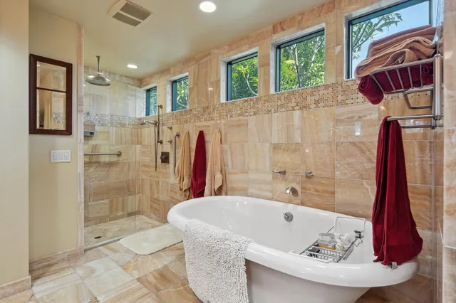 a spacious bathroom with double vanity and a mirror