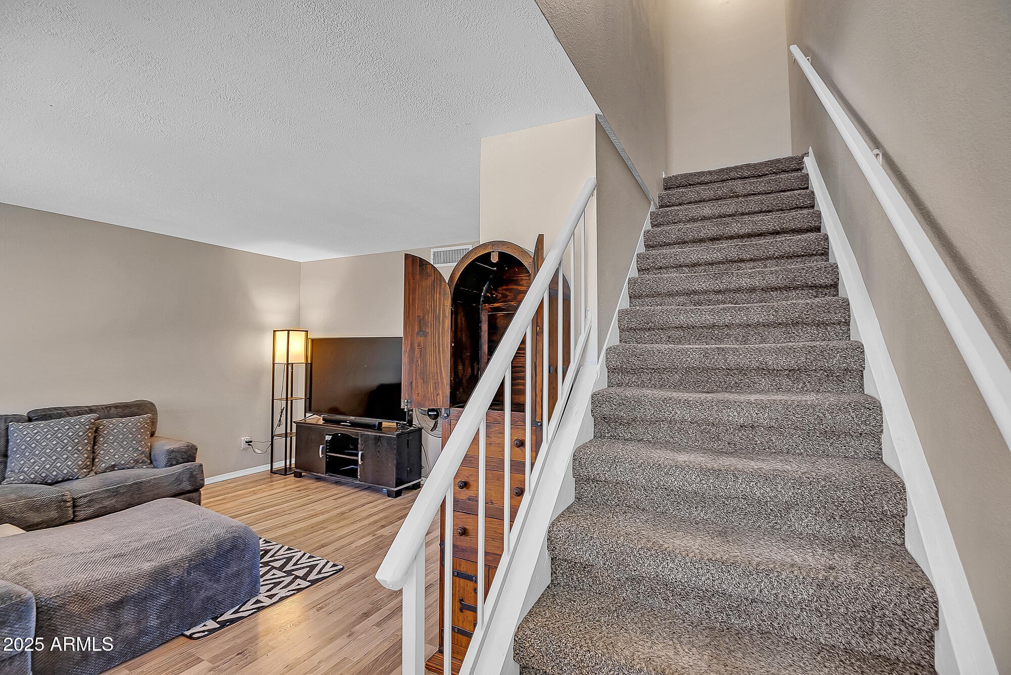 10100 North 89th Avenue, Unit 66 Peoria, AZ 85345 - Photo 6 of 32 Living Room Stairway