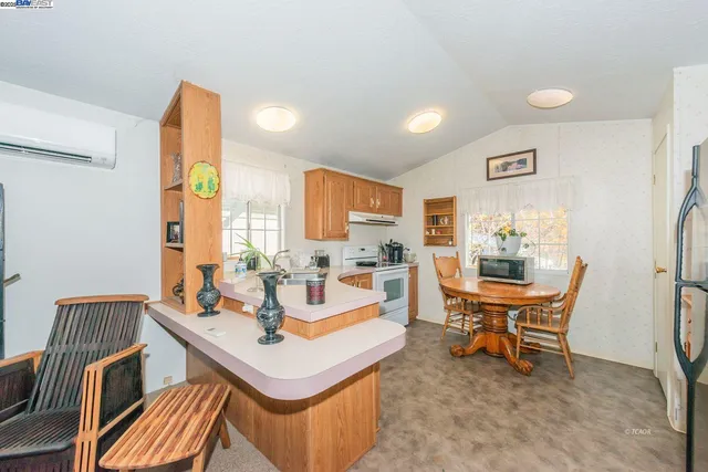 a kitchen with a sink stove top oven and cabinets