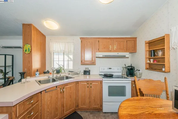 a room with stainless steel appliances furniture and a window