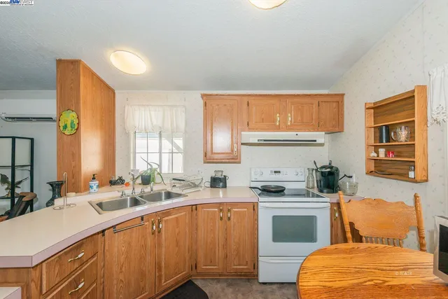 a room with stainless steel appliances furniture and a window
