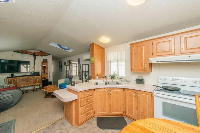 a view of a livingroom with furniture a flat screen tv and a window