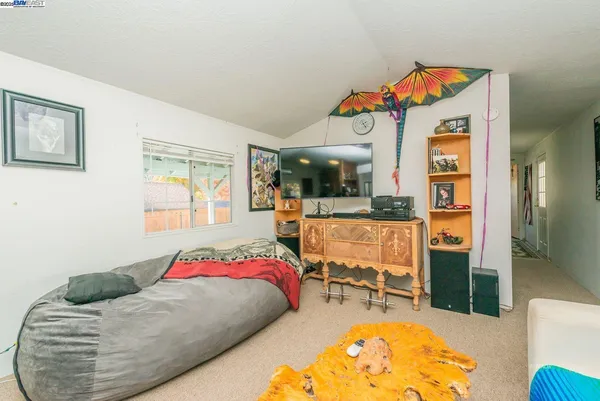 a living room with furniture a rug and a window