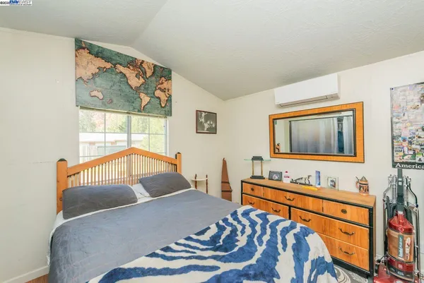 a view of a yard with plants and wooden fence