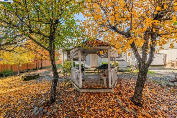 a view of a wooden house with a yard