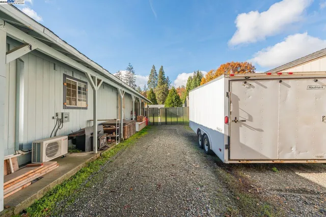 a view of a house with backyard and a tree