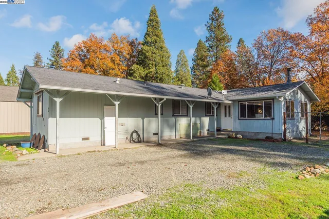 a view of a house with a garage and a chair