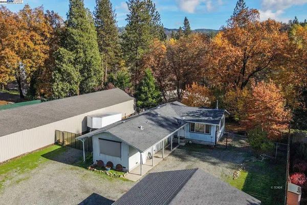 an aerial view of a house with a yard