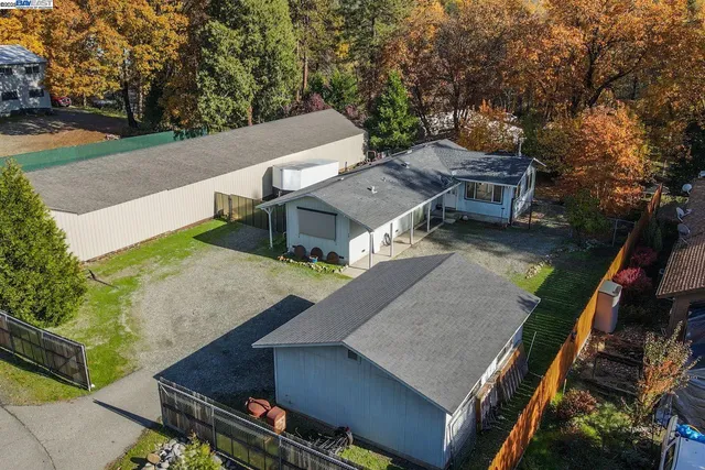an aerial view of a house with a yard